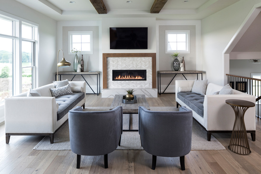 This is an example of a transitional living room in Minneapolis with grey walls, light hardwood floors, a ribbon fireplace, a tile fireplace surround and a wall-mounted tv.