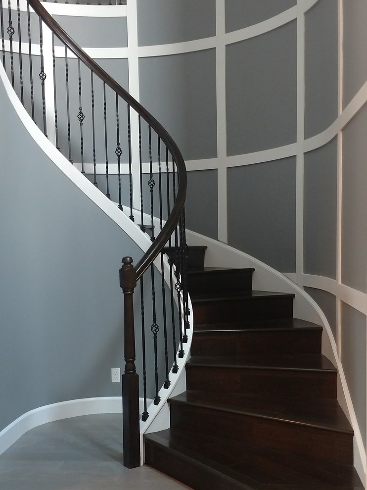 Large traditional wood curved staircase in Miami with wood risers and mixed railing.