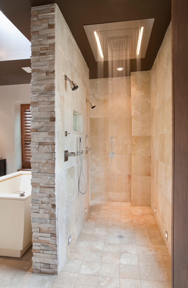 Photo of a contemporary bathroom in DC Metro with a double shower and travertine.