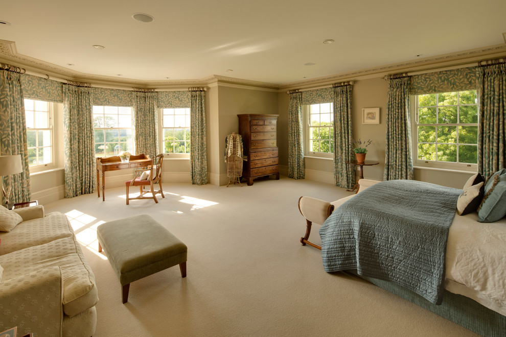 Design ideas for a large traditional master bedroom in Hampshire with beige walls and carpet.