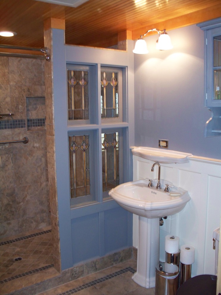 Design ideas for a mid-sized country master bathroom in Portland with glass-front cabinets, blue cabinets, an open shower, a two-piece toilet, blue tile, travertine, blue walls, travertine floors, a pedestal sink, glass benchtops, beige floor and an open shower.