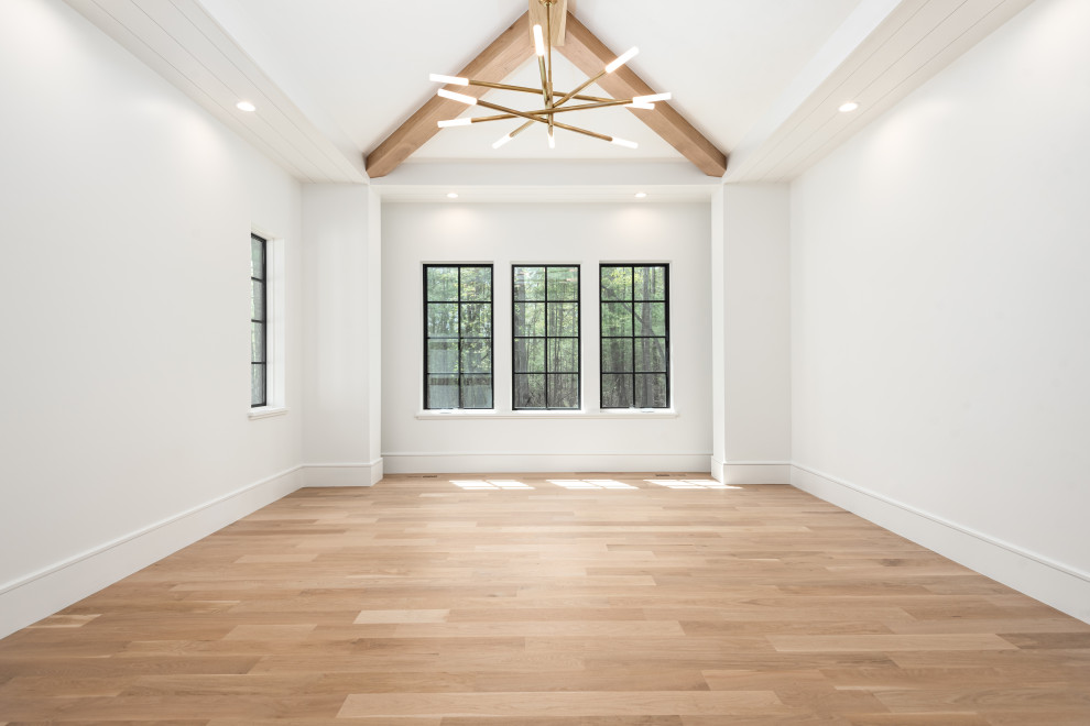 Mid-sized transitional master light wood floor and exposed beam bedroom photo with white walls and no fireplace