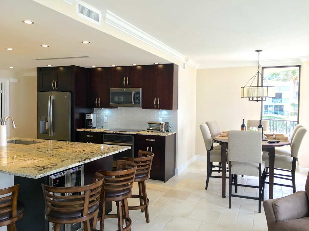 Inspiration for a mid-sized transitional beige floor eat-in kitchen remodel in Miami with beige walls, an undermount sink, shaker cabinets, dark wood cabinets, gray backsplash, stainless steel appliances and an island