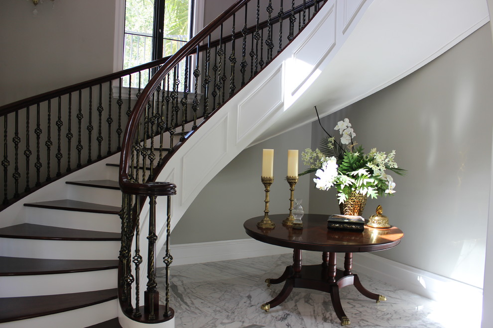 Mid-sized traditional wood curved staircase in Other with wood risers and mixed railing.