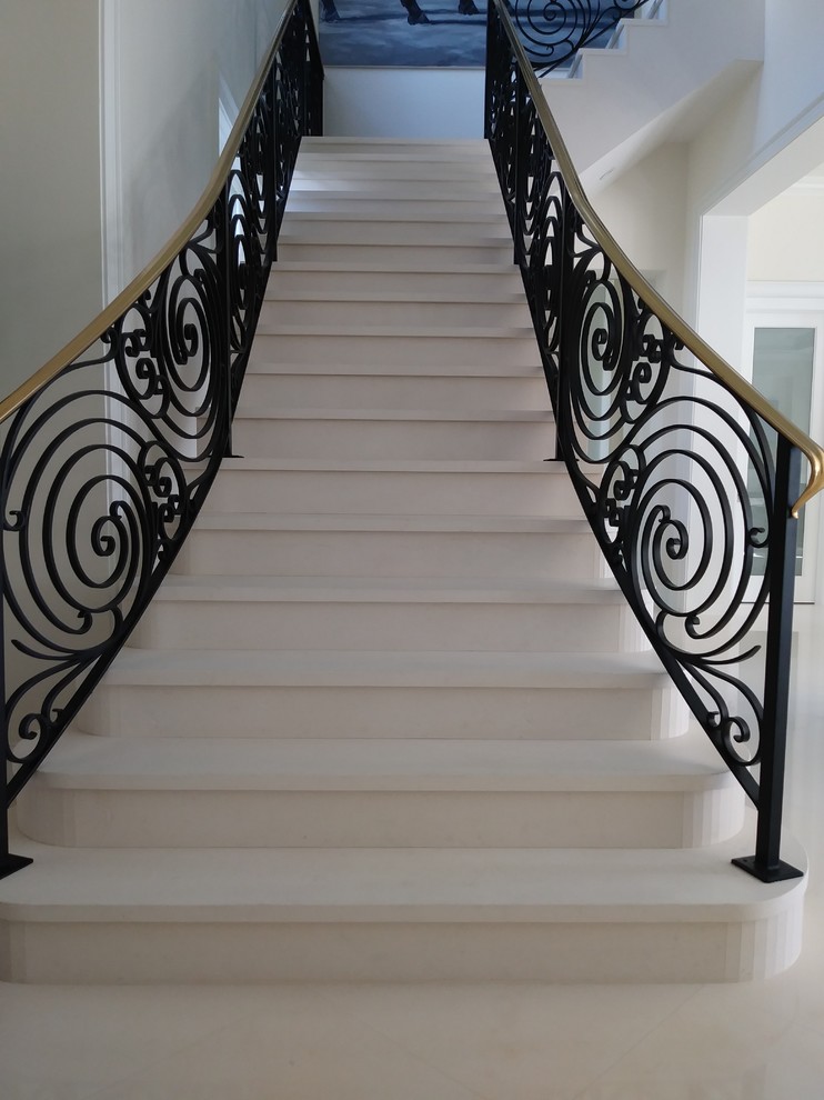 Inspiration for a large contemporary marble l-shaped staircase in Miami with marble risers and metal railing.
