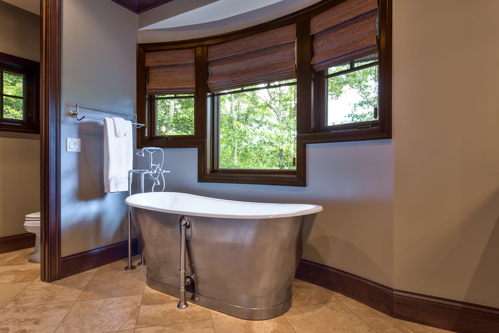 Large mountain style master beige floor freestanding bathtub photo with beige walls