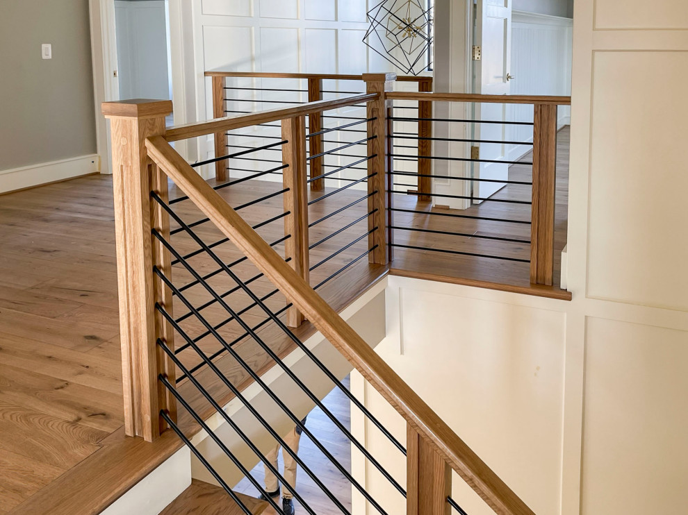 Inspiration for a large midcentury wood floating staircase in DC Metro with wood risers and mixed railing.