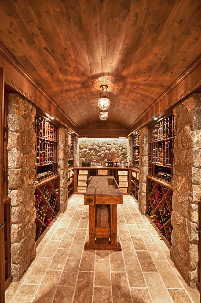 Design ideas for a traditional wine cellar in Boston with travertine floors and storage racks.