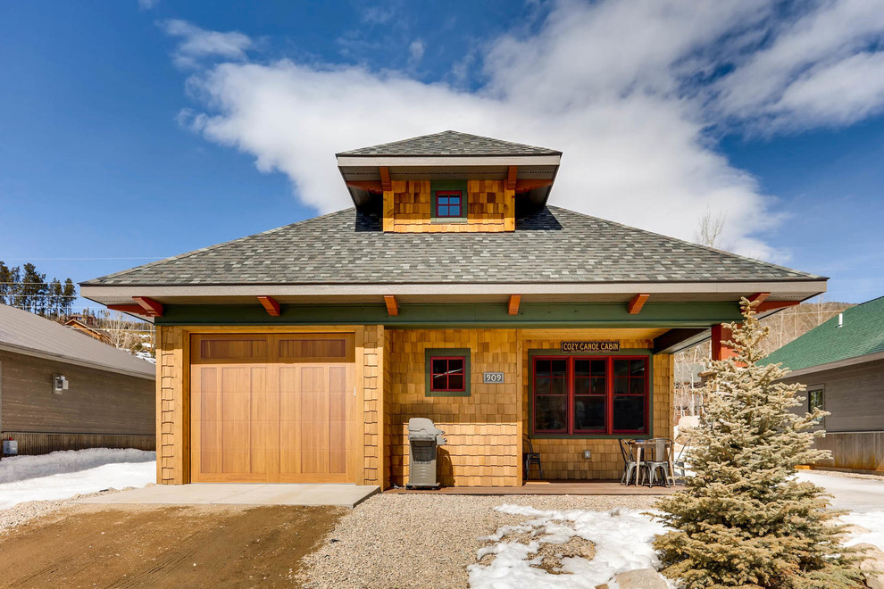This is an example of a mid-sized country two-storey brown house exterior in Denver with wood siding, a hip roof and a shingle roof.
