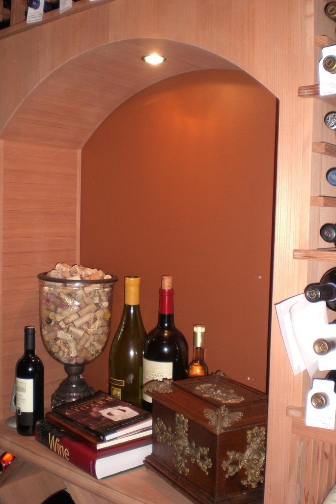 This is an example of a small transitional wine cellar in Orange County with storage racks.