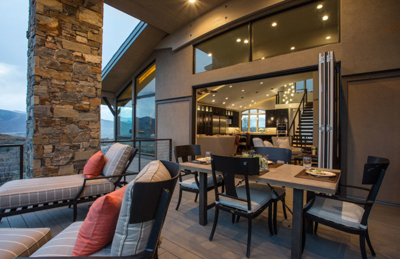 Inspiration for a mid-sized contemporary backyard deck in Salt Lake City with a fire feature and a roof extension.
