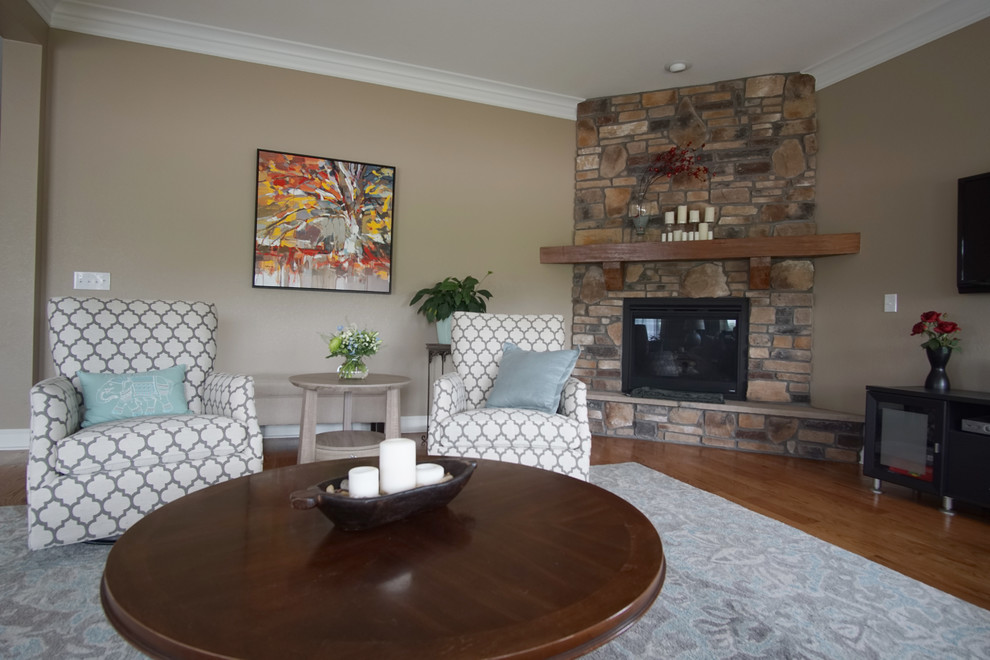 Inspiration for a large contemporary open concept living room in Denver with beige walls, light hardwood floors, a corner fireplace and a stone fireplace surround.