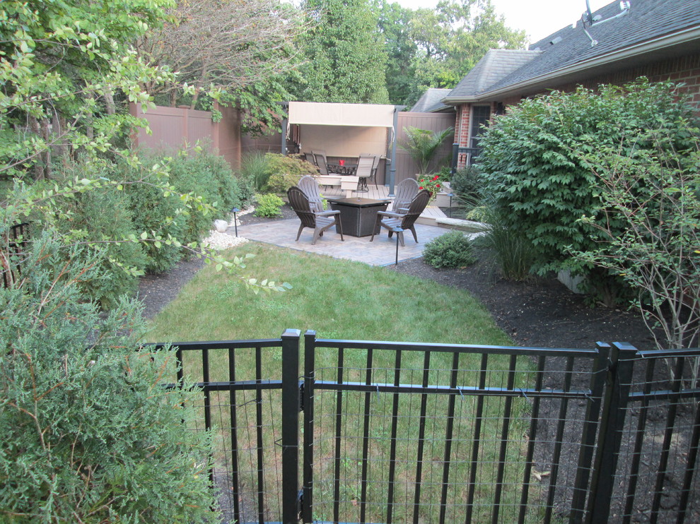 This is an example of a small transitional backyard landscaping.