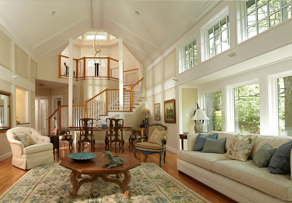 This is an example of a large traditional formal enclosed living room in Boston with beige walls, medium hardwood floors, no tv and a standard fireplace.