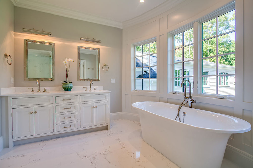 Example of a large transitional master marble floor and white floor freestanding bathtub design with recessed-panel cabinets, white cabinets, white walls, an undermount sink and a hinged shower door