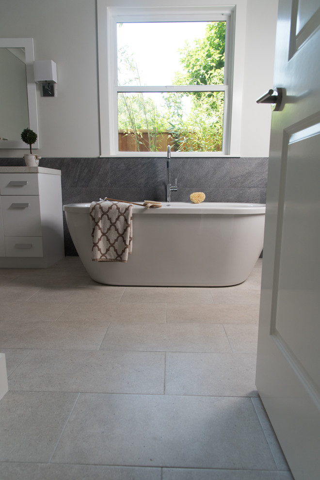 Photo of a large contemporary bathroom in San Francisco with a freestanding tub, a curbless shower, gray tile, ceramic tile and porcelain floors.