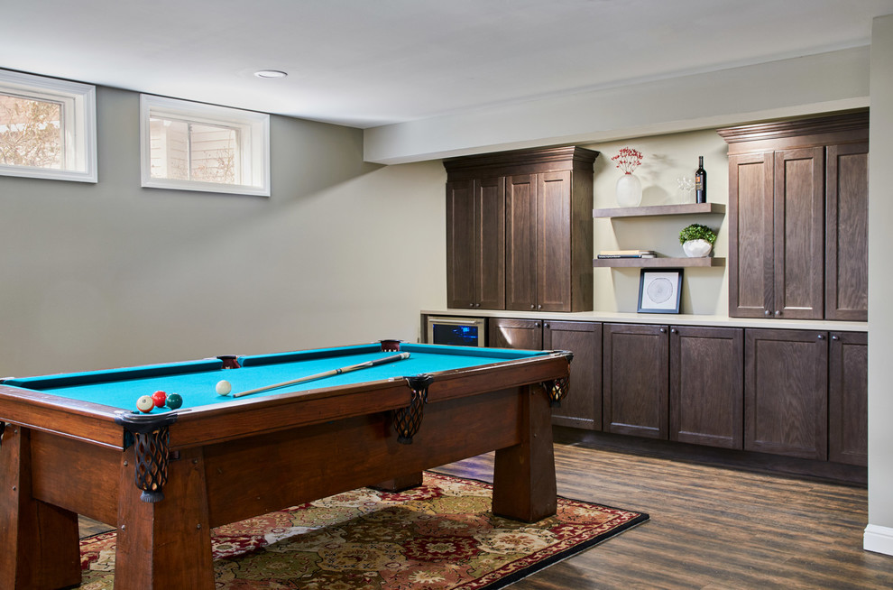 Example of a large mountain style walk-out vinyl floor and brown floor basement design in St Louis with gray walls and a standard fireplace