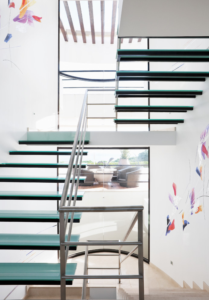Design ideas for a contemporary glass floating staircase in Other with open risers and metal railing.