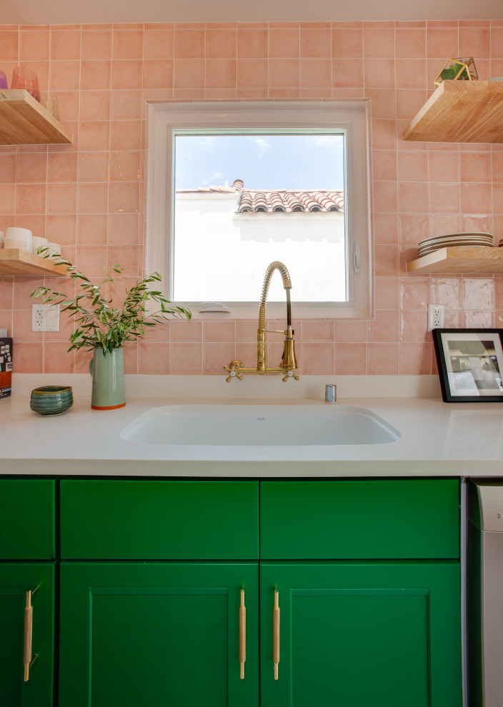 Inspiration for a small eclectic galley eat-in kitchen in Los Angeles with a drop-in sink, flat-panel cabinets, green cabinets, quartzite benchtops, pink splashback, ceramic splashback, stainless steel appliances, ceramic floors, white floor and white benchtop.
