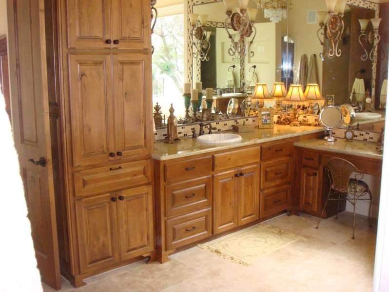 Inspiration for a transitional beige tile bathroom remodel in Austin with raised-panel cabinets and medium tone wood cabinets