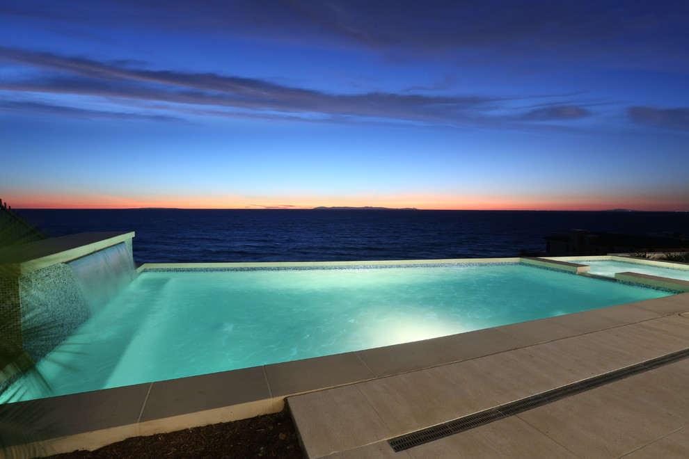 Example of a mid-sized backyard rectangular pool fountain design in Orange County