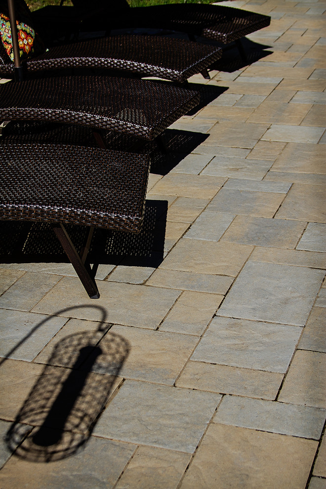 Large mountain style backyard concrete paver and custom-shaped natural hot tub photo in Raleigh