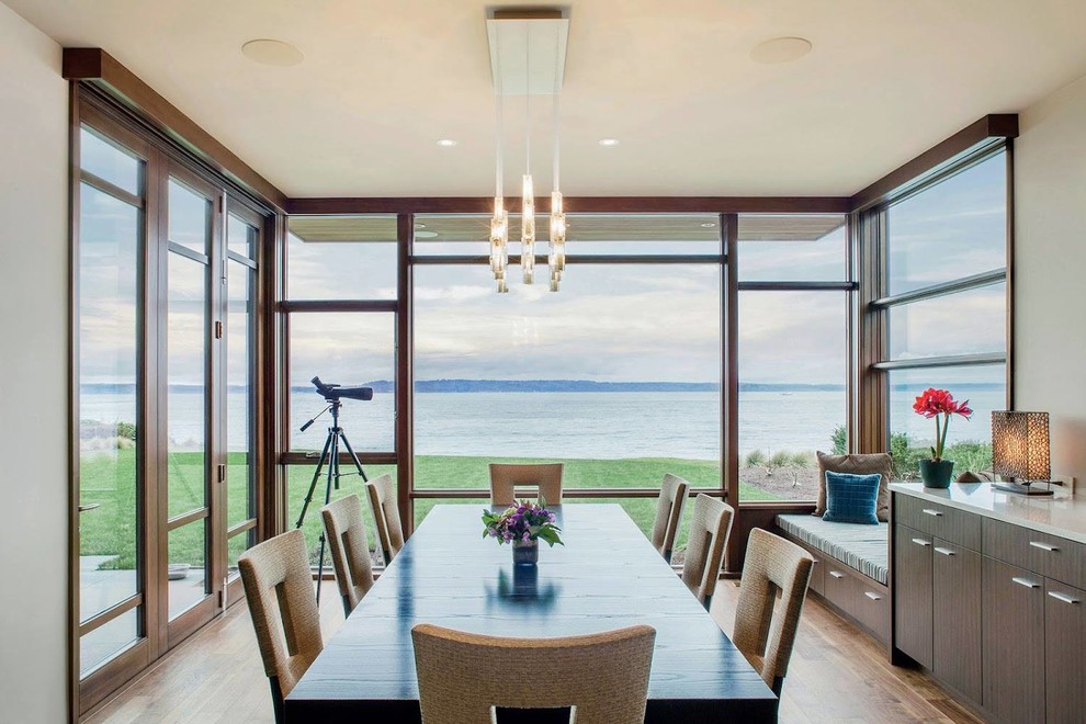 Photo of a contemporary dining room in Seattle with beige walls and medium hardwood floors.