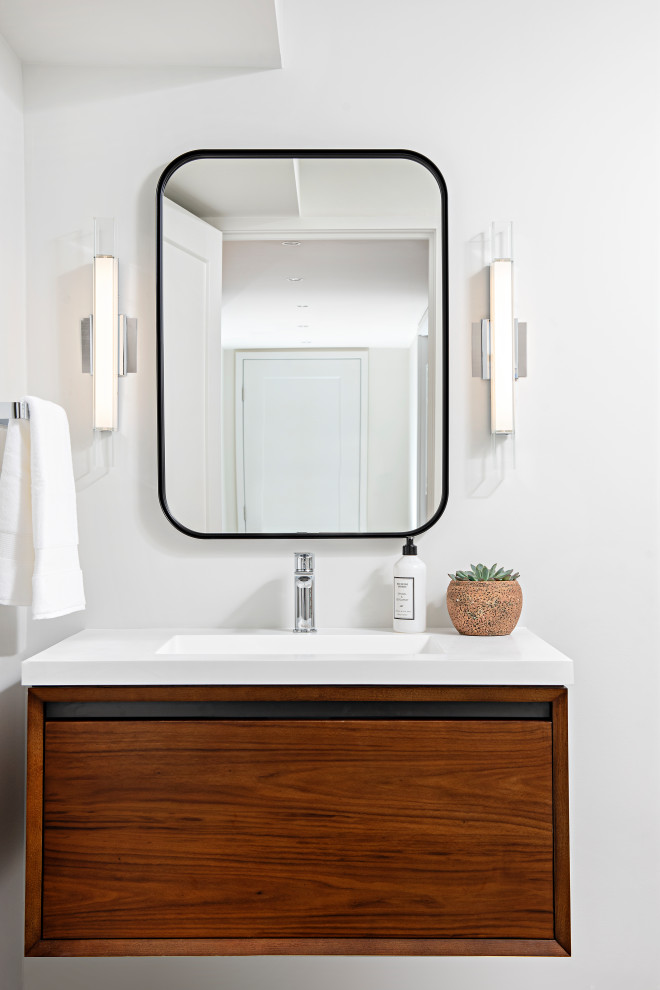 Foto de cuarto de baño único y flotante actual de tamaño medio con armarios con paneles lisos, puertas de armario de madera oscura y encimeras blancas