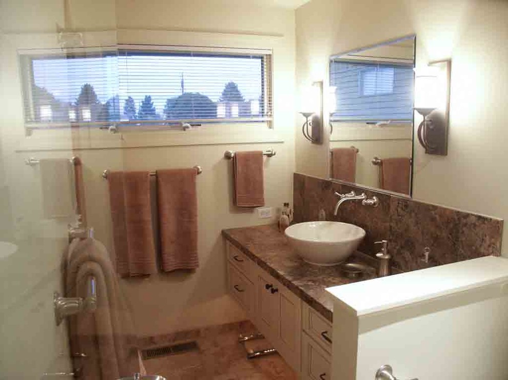 Example of a mid-sized transitional master brown tile and ceramic tile porcelain tile freestanding bathtub design with a vessel sink, recessed-panel cabinets, medium tone wood cabinets, granite countertops, a two-piece toilet and gray walls