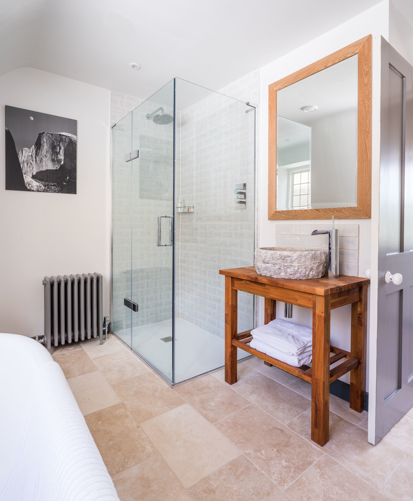 Inspiration for a mid-sized transitional bathroom in Other with white walls, a vessel sink, wood benchtops, beige floor, a hinged shower door, brown benchtops, a claw-foot tub, a curbless shower and beige tile.