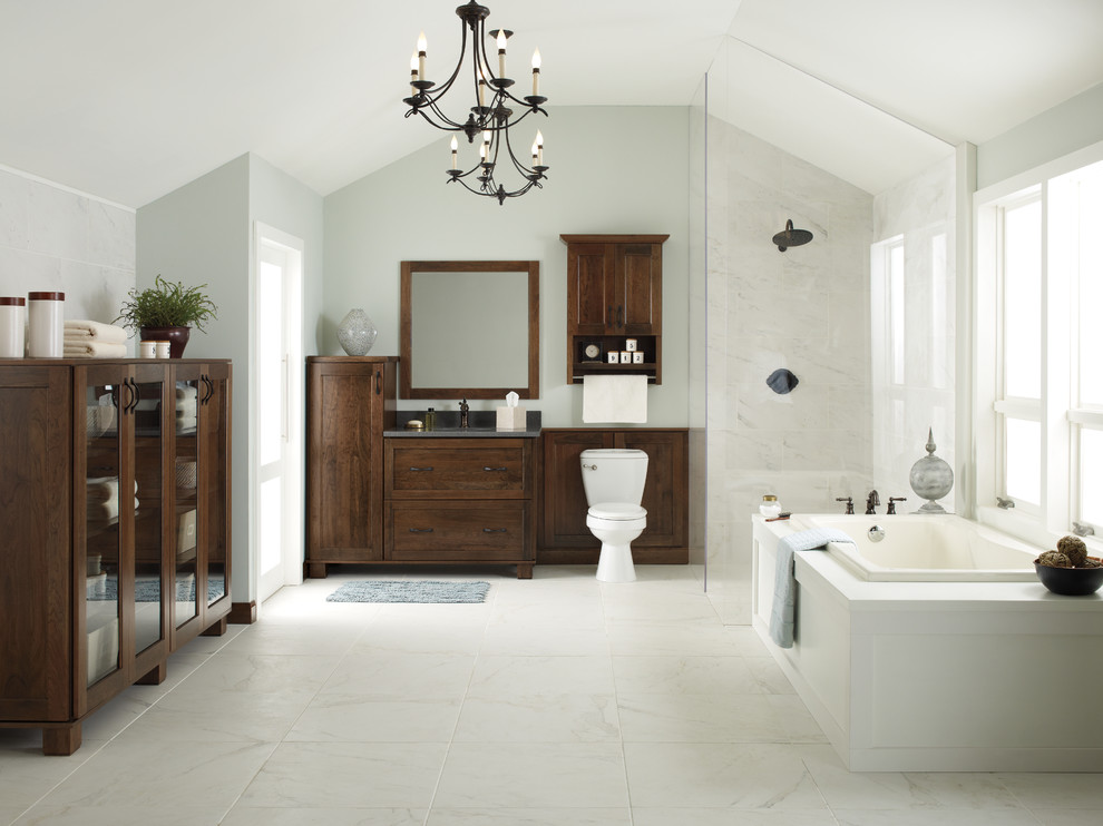 Design ideas for an expansive contemporary master bathroom in Detroit with a drop-in sink, furniture-like cabinets, dark wood cabinets, granite benchtops, a freestanding tub, an open shower, a one-piece toilet, white tile, porcelain tile, grey walls and marble floors.