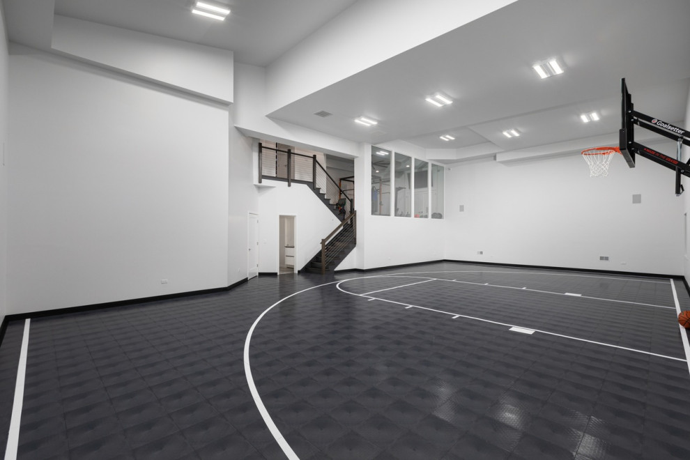 Photo of a large modern indoor sport court in Chicago with white walls, vinyl floors, grey floor and vaulted.
