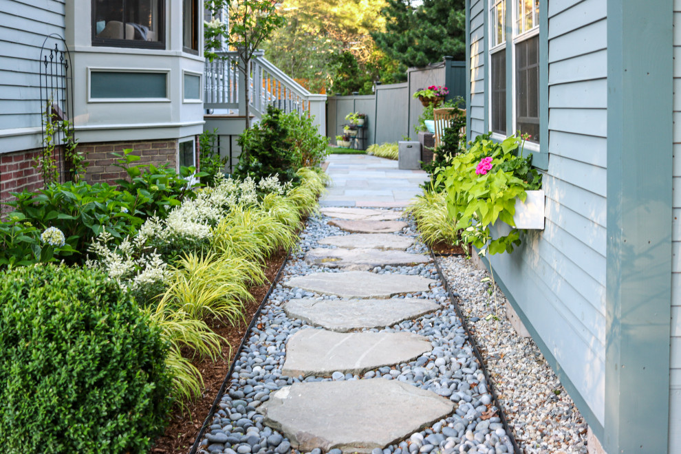 This is an example of a small contemporary side yard partial sun garden for spring in Boston with with rock feature and river rock.