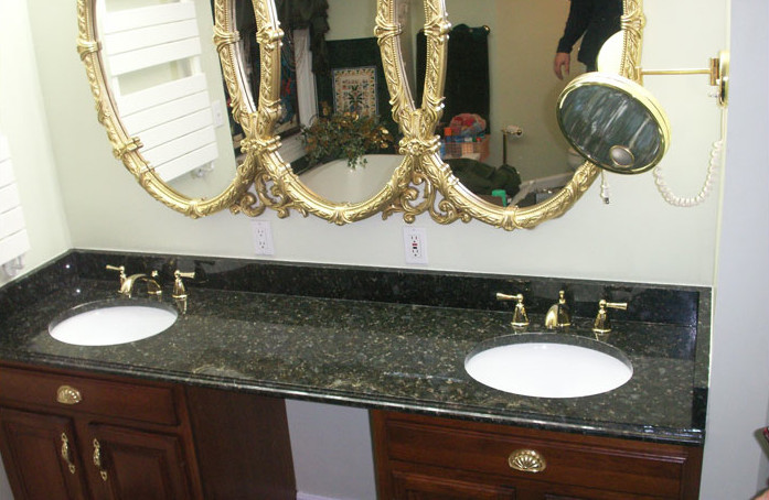 Bathroom - mid-sized bathroom idea in Boston with an integrated sink, raised-panel cabinets, medium tone wood cabinets, granite countertops and white walls
