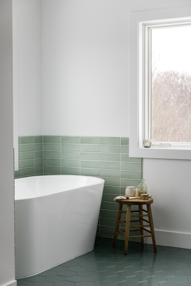 Photo of a large scandinavian master bathroom in Grand Rapids with flat-panel cabinets, white cabinets, a freestanding tub, an alcove shower, green tile, ceramic tile, white walls, ceramic floors, an undermount sink, quartzite benchtops, green floor, a hinged shower door and white benchtops.
