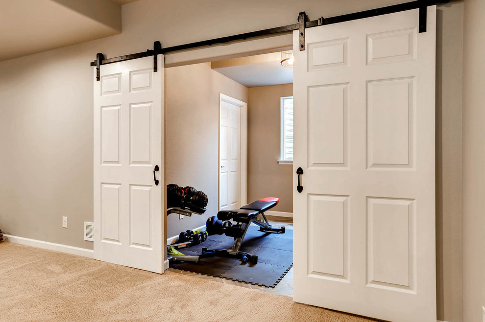 Design ideas for a mid-sized home weight room in Denver with beige walls, ceramic floors and brown floor.