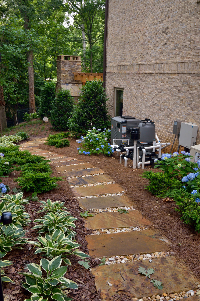 Large contemporary side yard partial sun garden in Atlanta with a garden path and natural stone pavers.