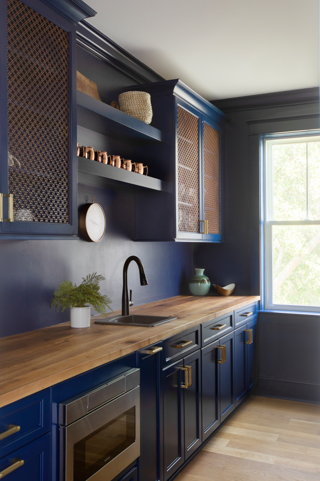 Inspiration for a beach style kitchen pantry in Charleston with a drop-in sink, recessed-panel cabinets, blue cabinets, quartz benchtops, blue splashback, stainless steel appliances and with island.