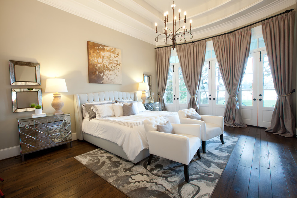 This is an example of a traditional bedroom in Dallas with beige walls and dark hardwood floors.