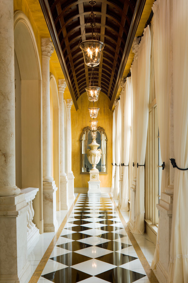This is an example of a traditional hallway in Miami with yellow walls.