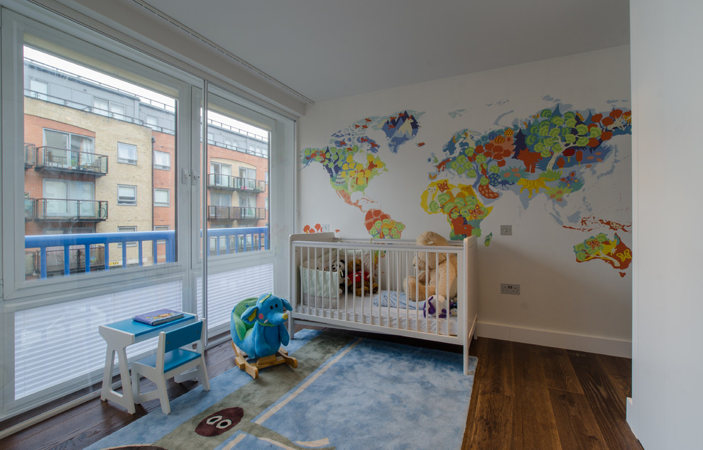 Design ideas for a mid-sized contemporary gender-neutral kids' bedroom for kids 4-10 years old in London with white walls and dark hardwood floors.