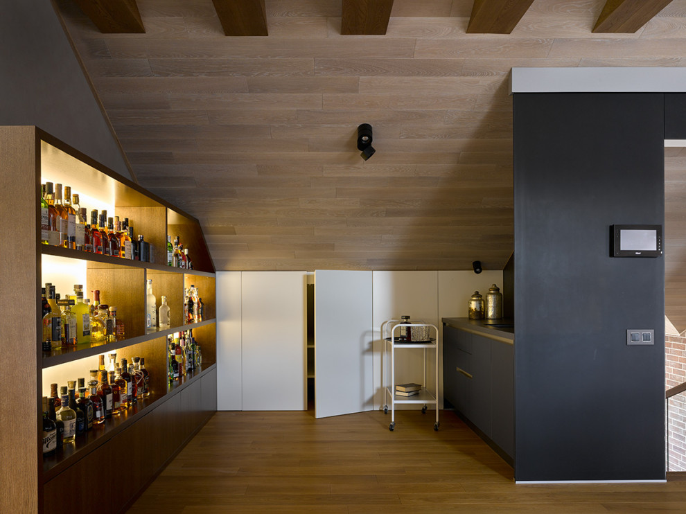 This is an example of a mid-sized contemporary single-wall wet bar in Moscow with flat-panel cabinets, black cabinets, black splashback, medium hardwood floors, beige floor and grey benchtop.