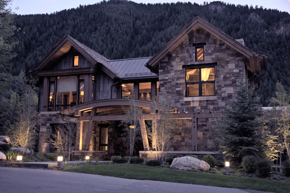 This is an example of a contemporary exterior in Denver with stone veneer and a mixed roof.