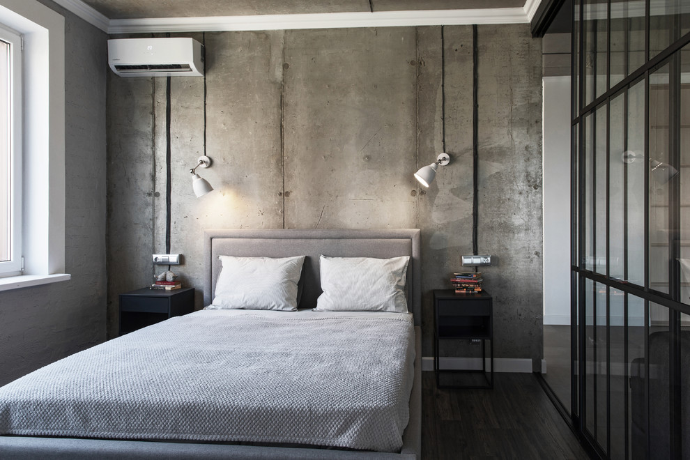 Design ideas for an industrial master bedroom in Other with grey walls and black floor.