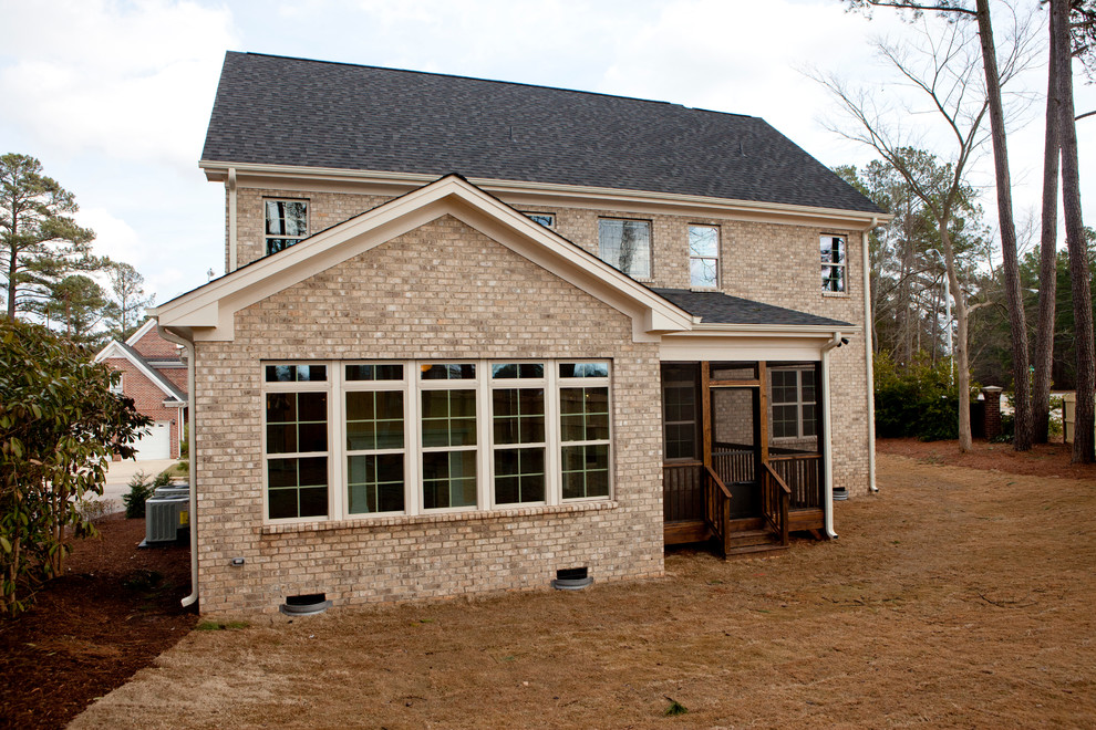 Design ideas for a mid-sized country two-storey beige exterior in Raleigh with stone veneer.