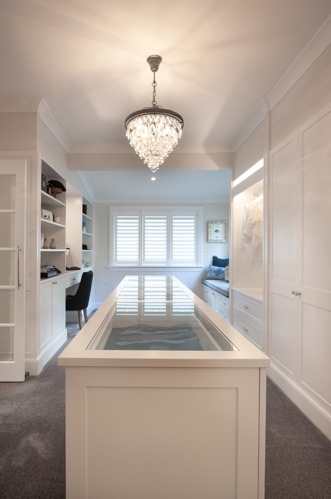 This is an example of a large transitional dressing room in Sydney with shaker cabinets, white cabinets and carpet.