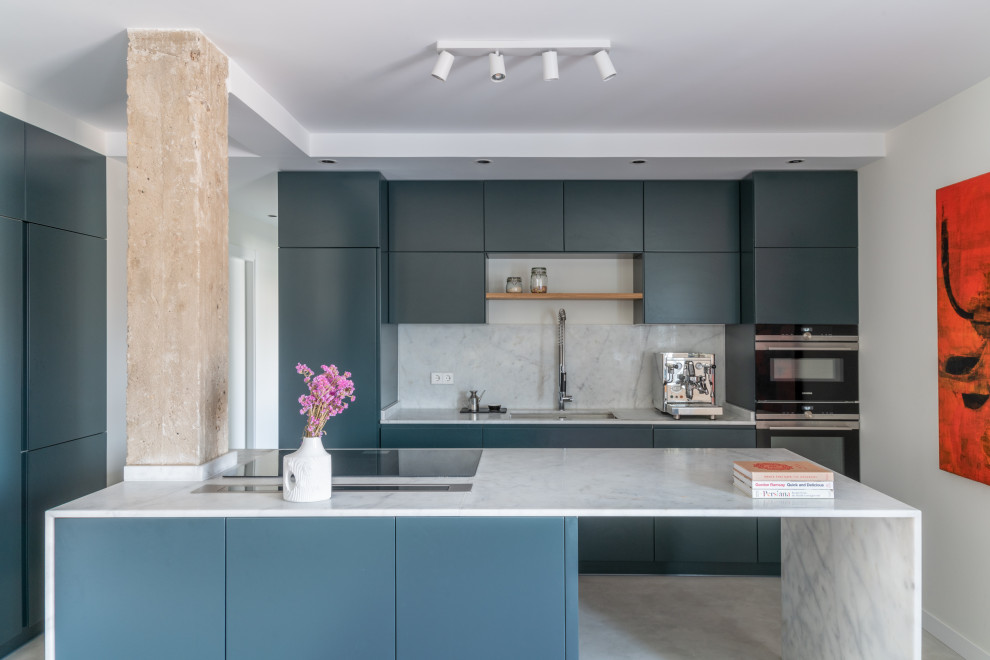 Photo of a contemporary l-shaped kitchen in Madrid with flat-panel cabinets, grey cabinets, marble benchtops, white splashback, marble splashback, stainless steel appliances, concrete floors, with island, grey floor, white benchtop and an undermount sink.