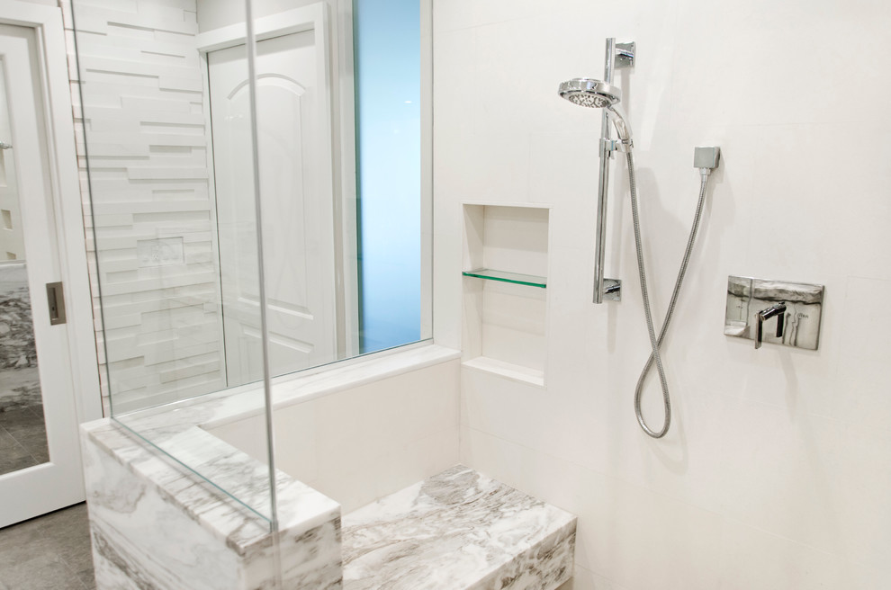 Photo of a mid-sized contemporary master bathroom in Orange County with white cabinets, an open shower, white tile, stone tile and pebble tile floors.