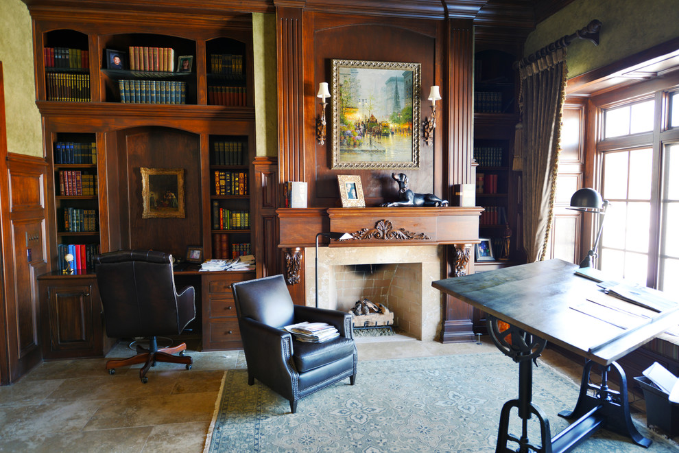 Photo of a large traditional study room in Indianapolis with porcelain floors, a standard fireplace, a built-in desk, a wood fireplace surround, beige floor and green walls.