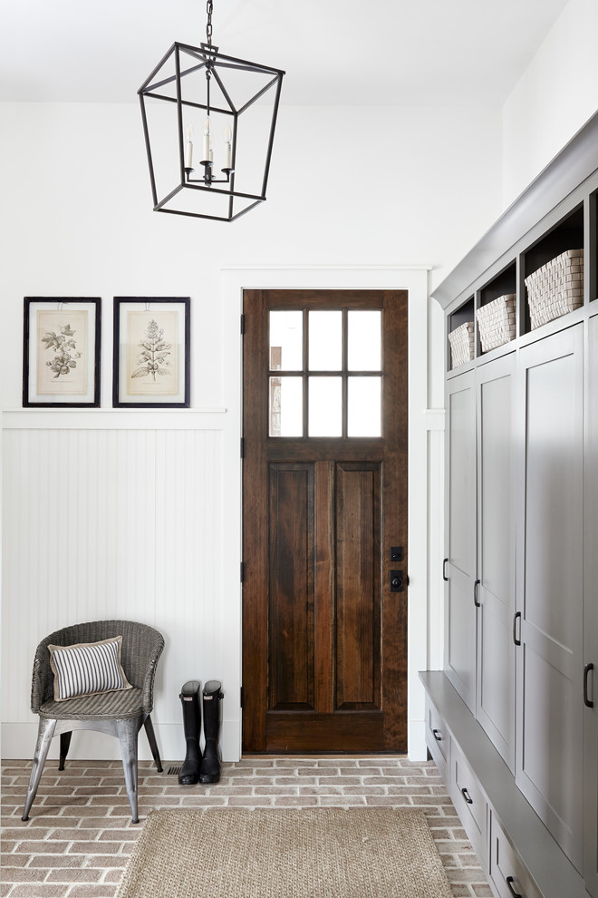 Mudroom - mid-sized country brick floor and red floor mudroom idea in Philadelphia with white walls